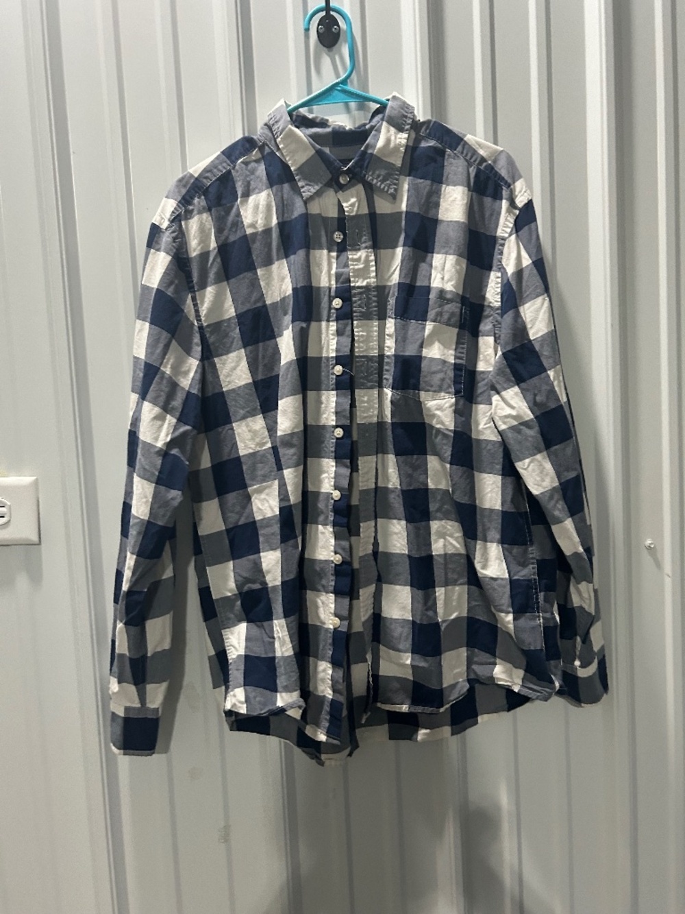 Blue white plaid button up shirt.